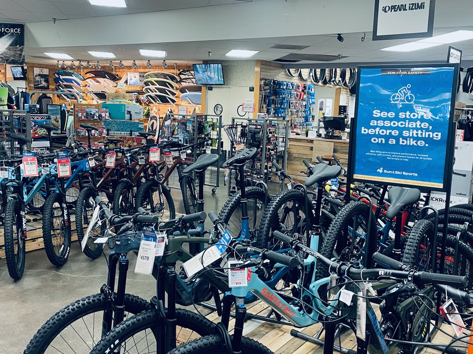 Wall of skis and ski boots at a Sun & Ski Sports shop in Phoenix, Arizona.