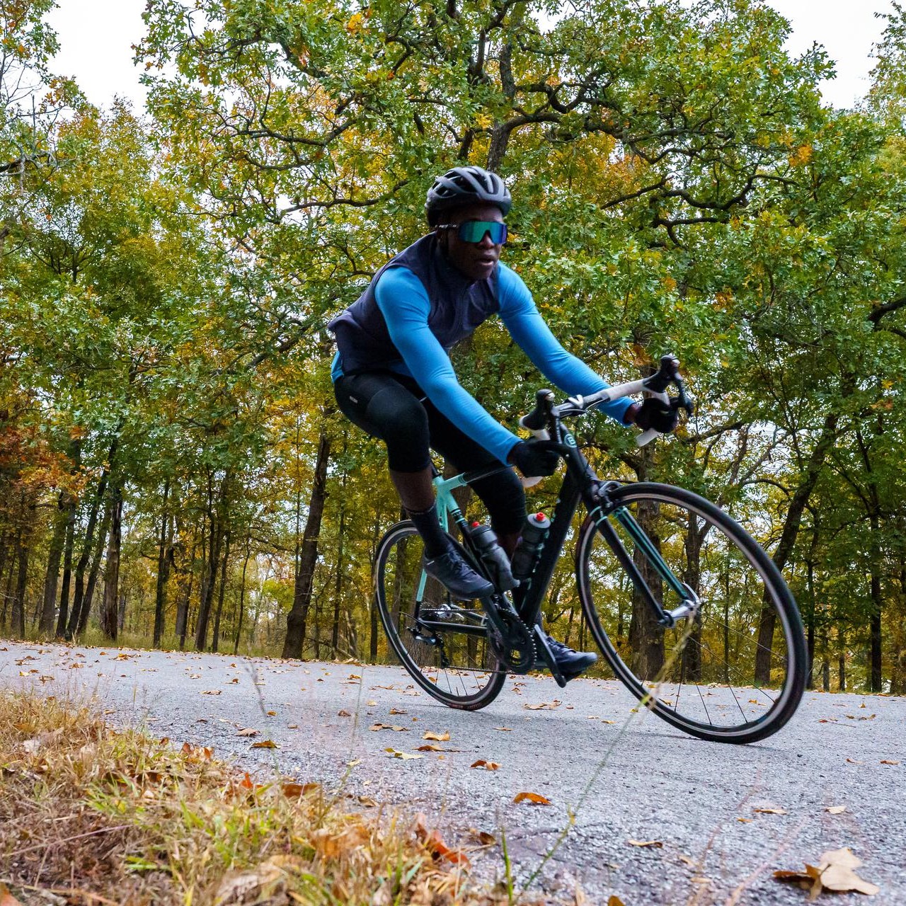 A man taking a sharp turn on his bike ride.