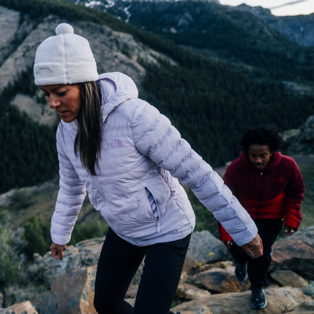 Friends hiking and wearing insulators to keep warm.