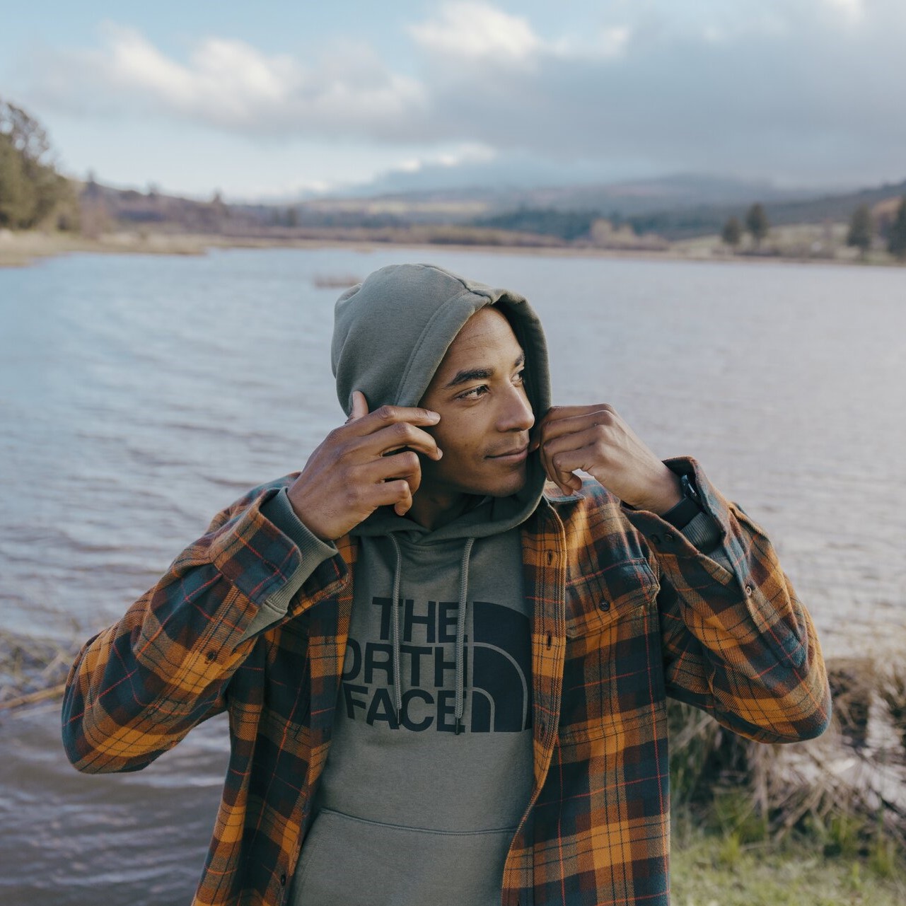 A man layering up outside with The North Face layers.