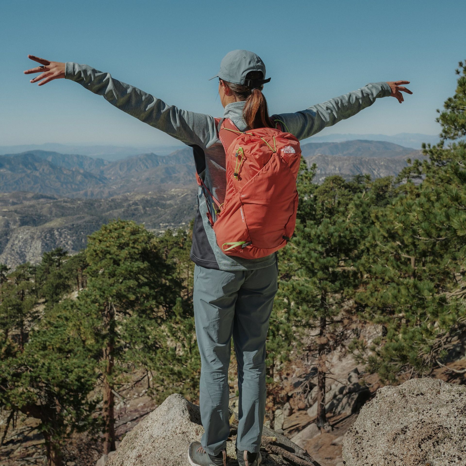 Woman looking over the mountains on her hike.
