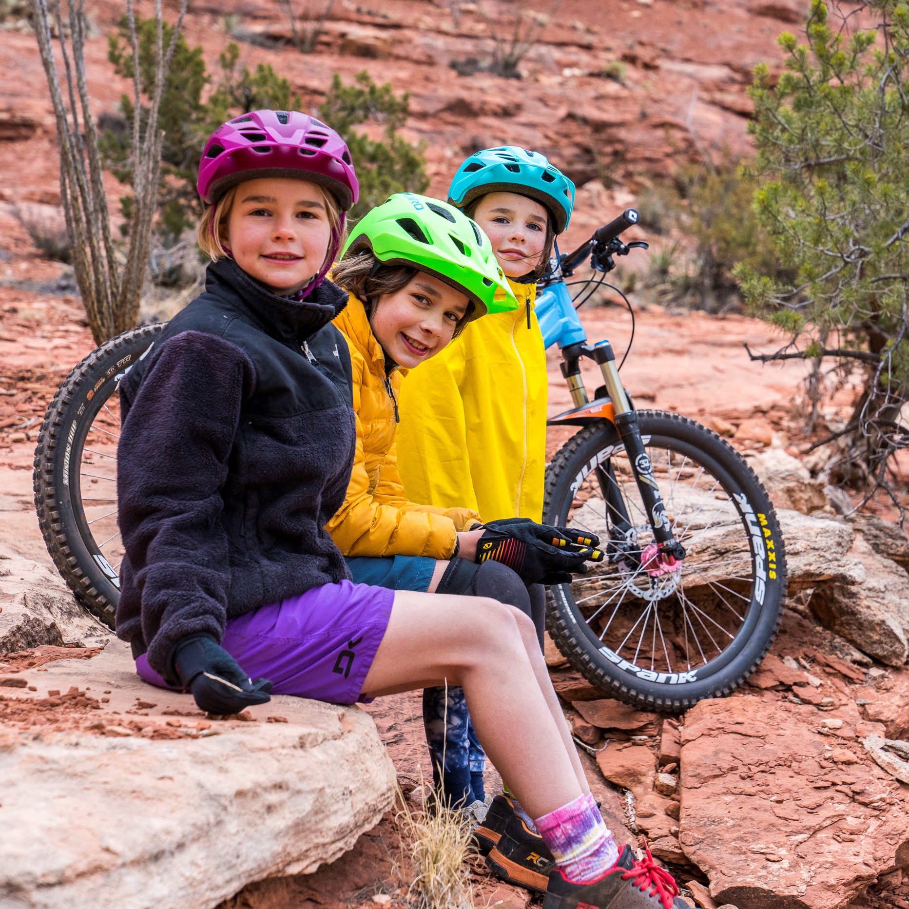 A group of kids riding on a trail.