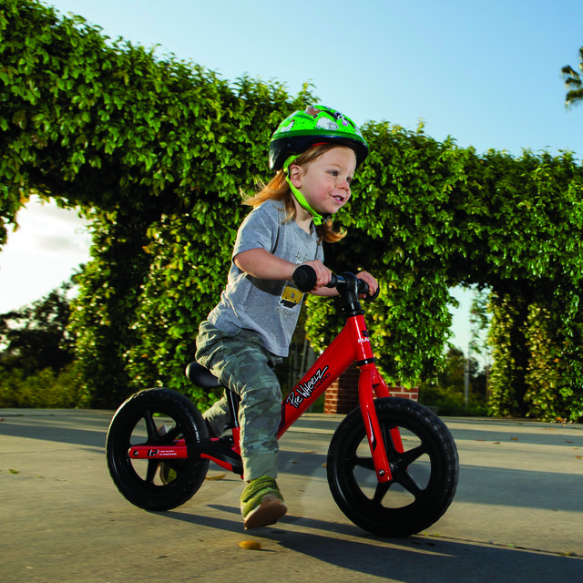 A child riding a bike and having a lot of fun.
