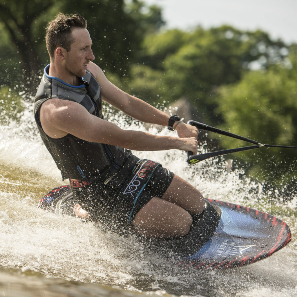 A man catching some air while doing a trick on a kneeboard.