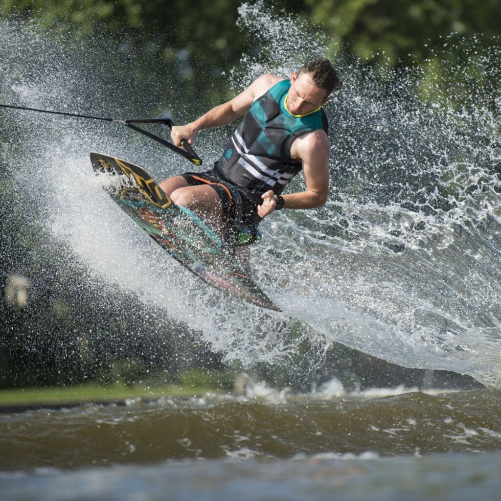 A man catching some air while doing a trick on a kneeboard.