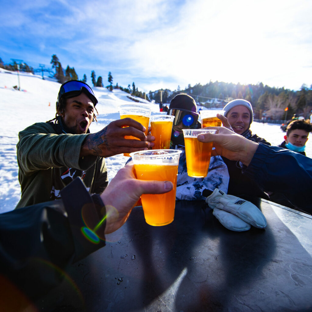A group of friends drinking some beer after a long day on the mountain.