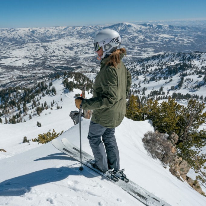 A female skier taking in the mountain sights.