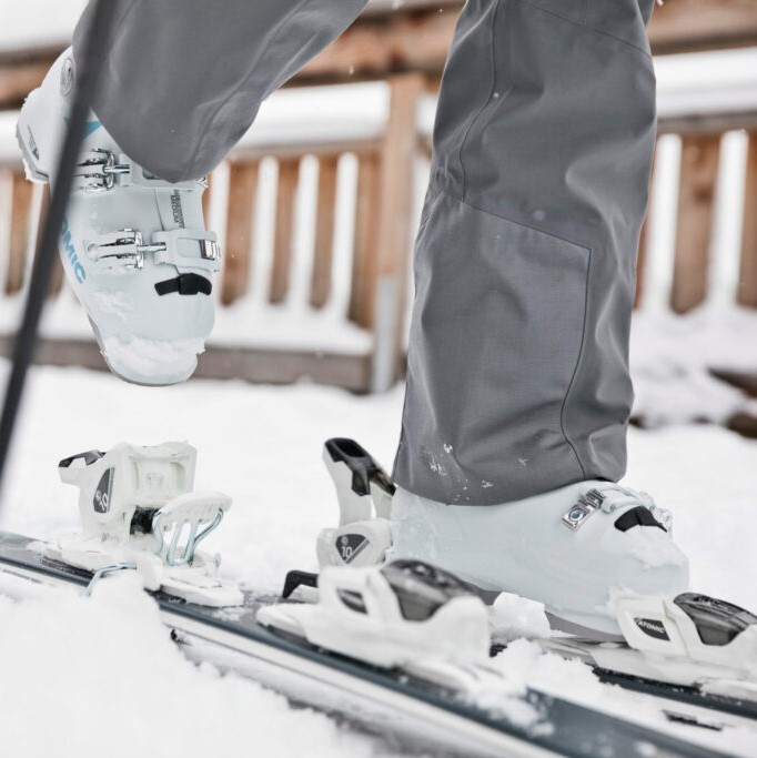 Stepping into a pair of skis.