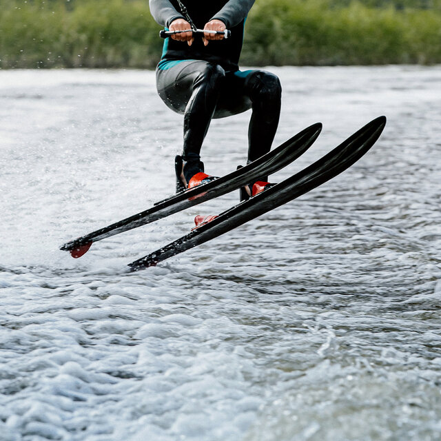 A man in a wetsuit for water skiing.