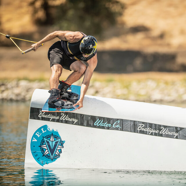 Wakeboarder Cody Hesse sliding a beam on a Hyperlite Wakeboard.
