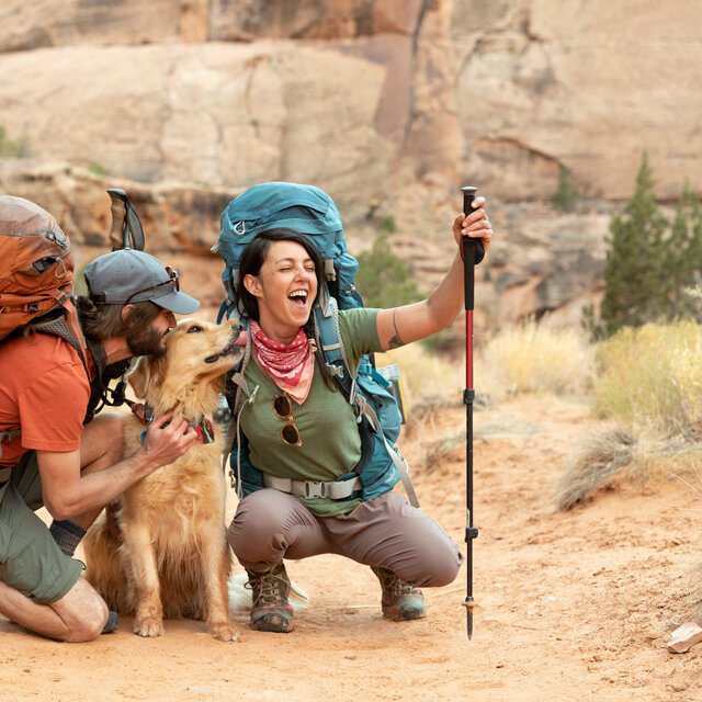 Two hikers and a golden retriever dog in Keen Hiking Boots.