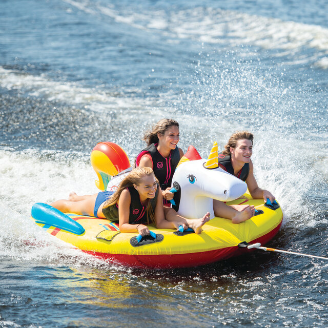 A family having fun on an HO Sports unicorn towable raft.