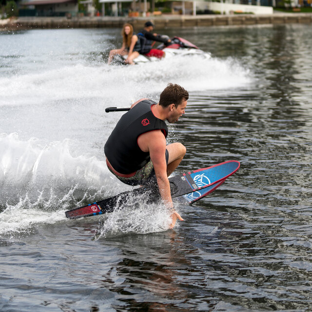Male water skier making a turn.