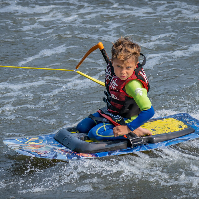 A boy on a HO Sports kneeboard.