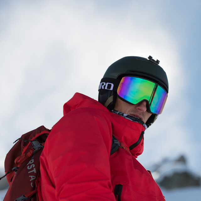 A man looking back wearing a Giro Helmet and Goggles.