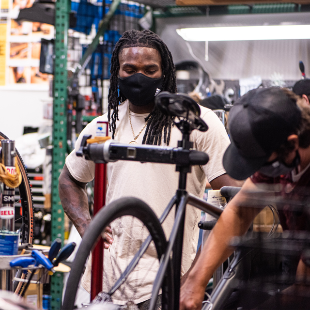 Jaylon Smith recieving top-notch service from Sun & Ski Sports Bike Techs.