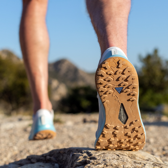 A runner on a dirt trail.