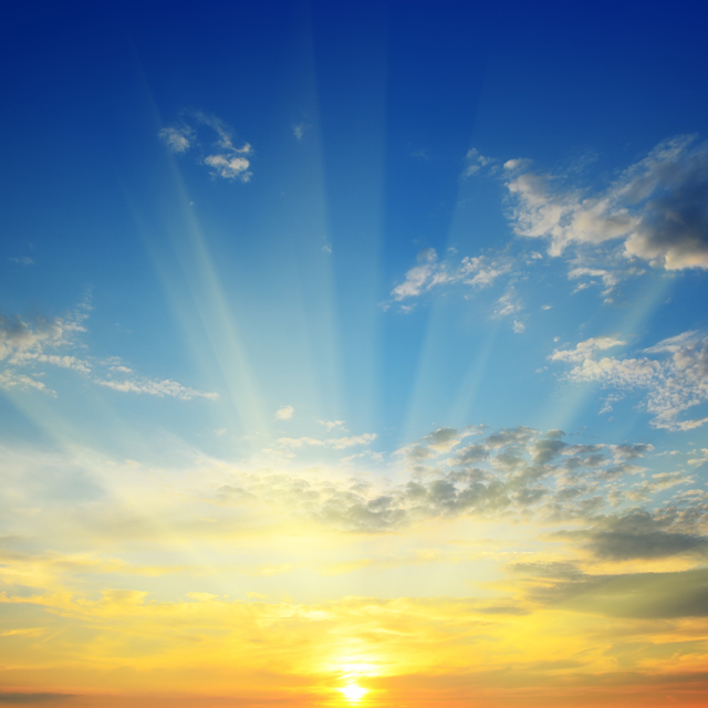 An early morning sunrise with orange, yellows, and blues throughout.