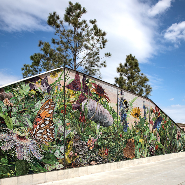 Complex and beautiful mural depicting flowers, insects, and plants.