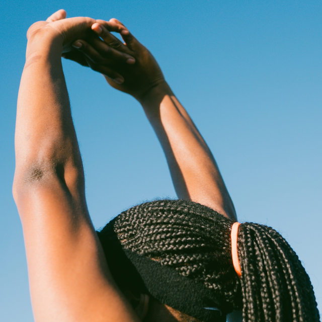 Person stretching arms overhead.