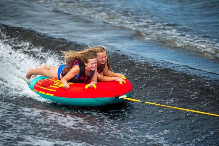 children swimming on lake