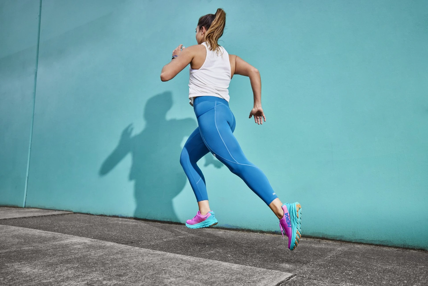 woman running in hoka rincon shoes