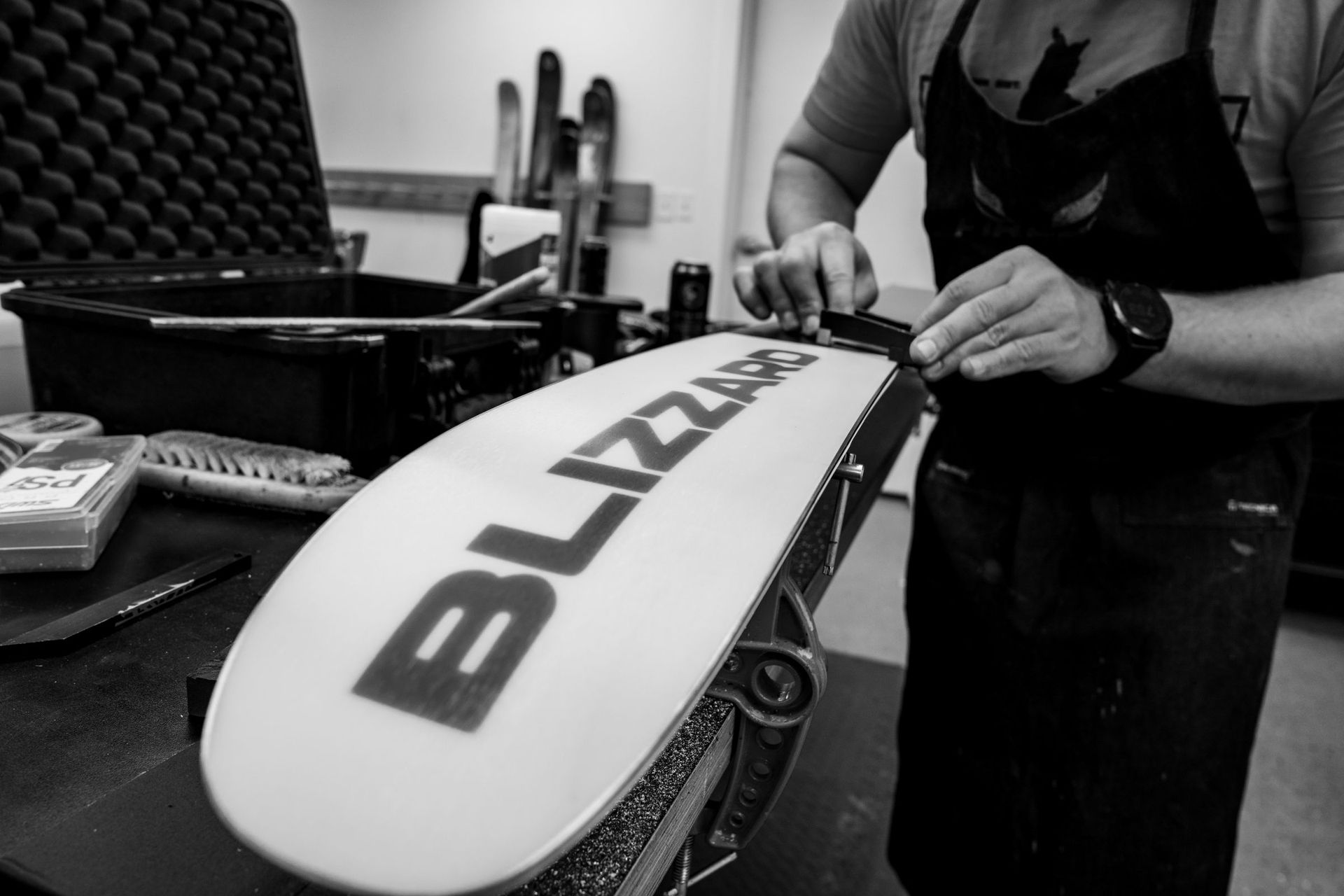 Outdoor Expert doing a basic ski tune, including sharpening the edges.