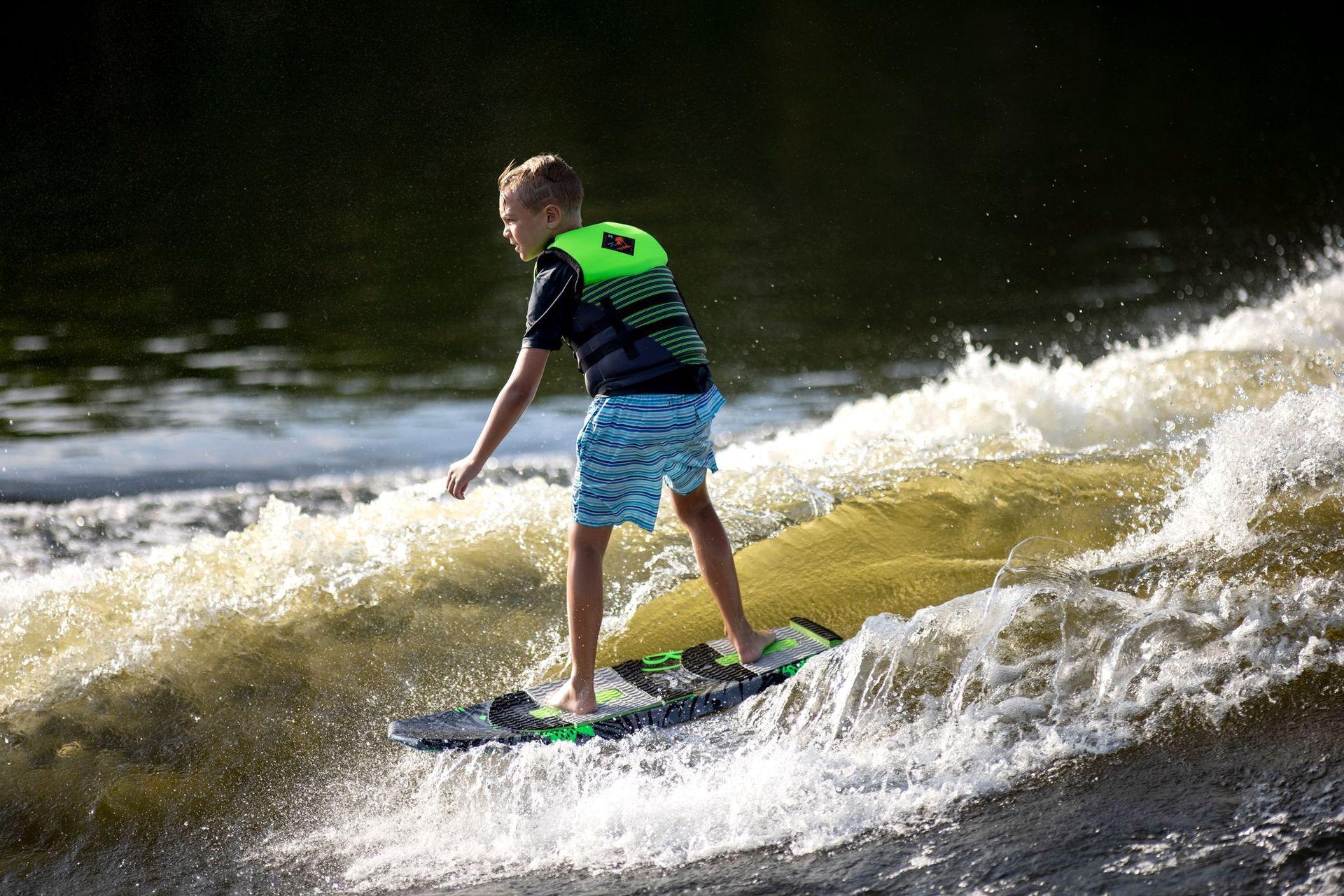 Child wearing a properly fitted youth life vest for wakeboarding