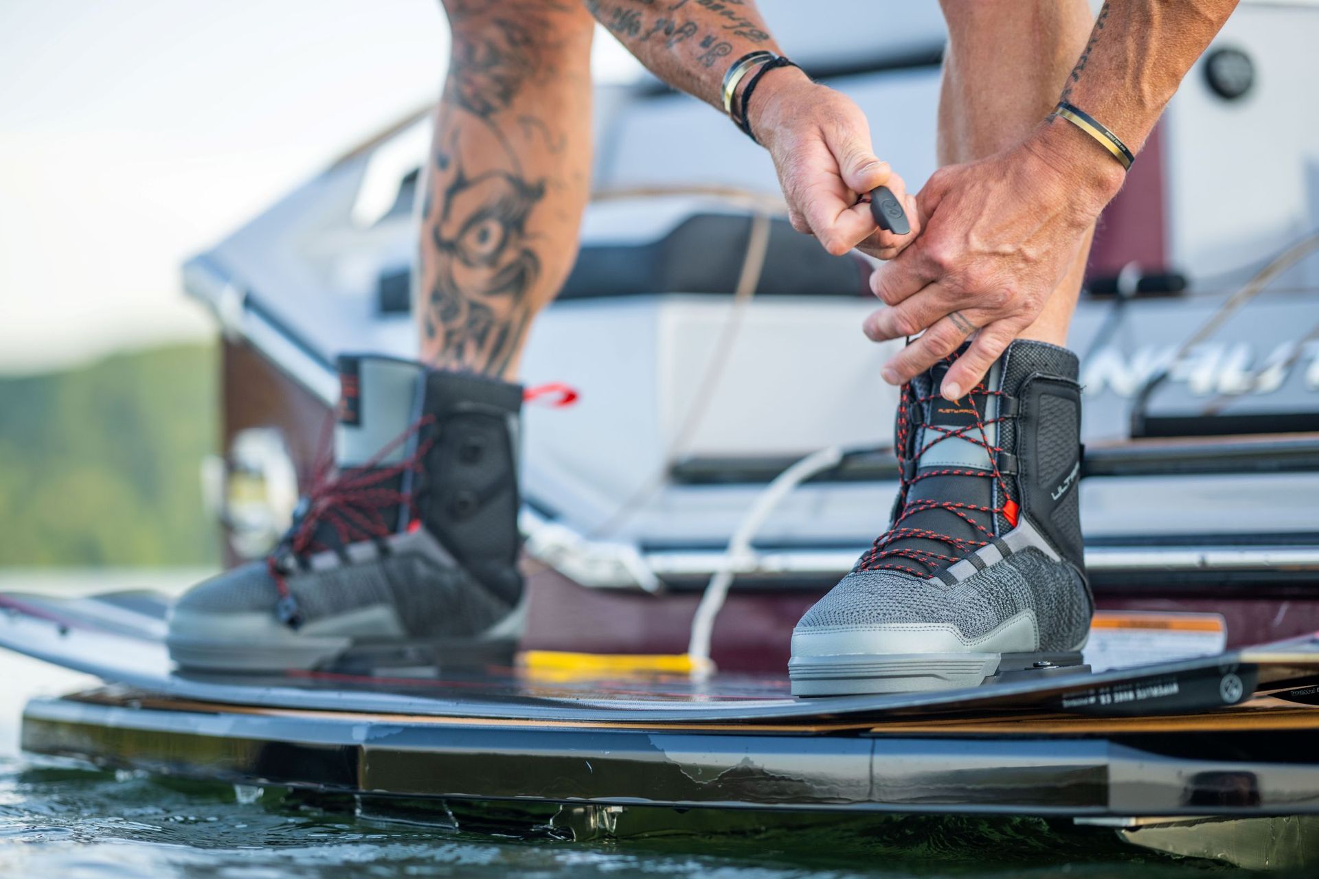 Experienced rider checking his wakeboarding gear before hitting the lake.