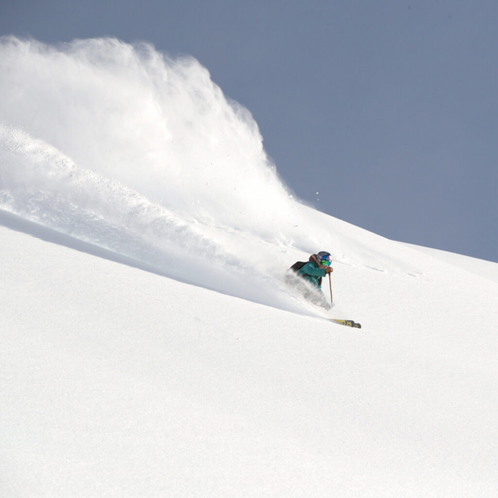 A skier going through pristine powder.
