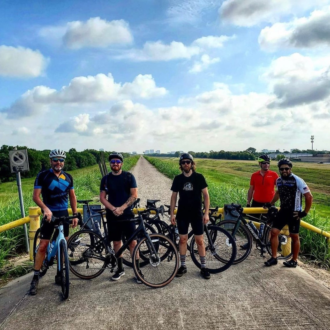 A group of cyclists in Houston partake in bike path riding.