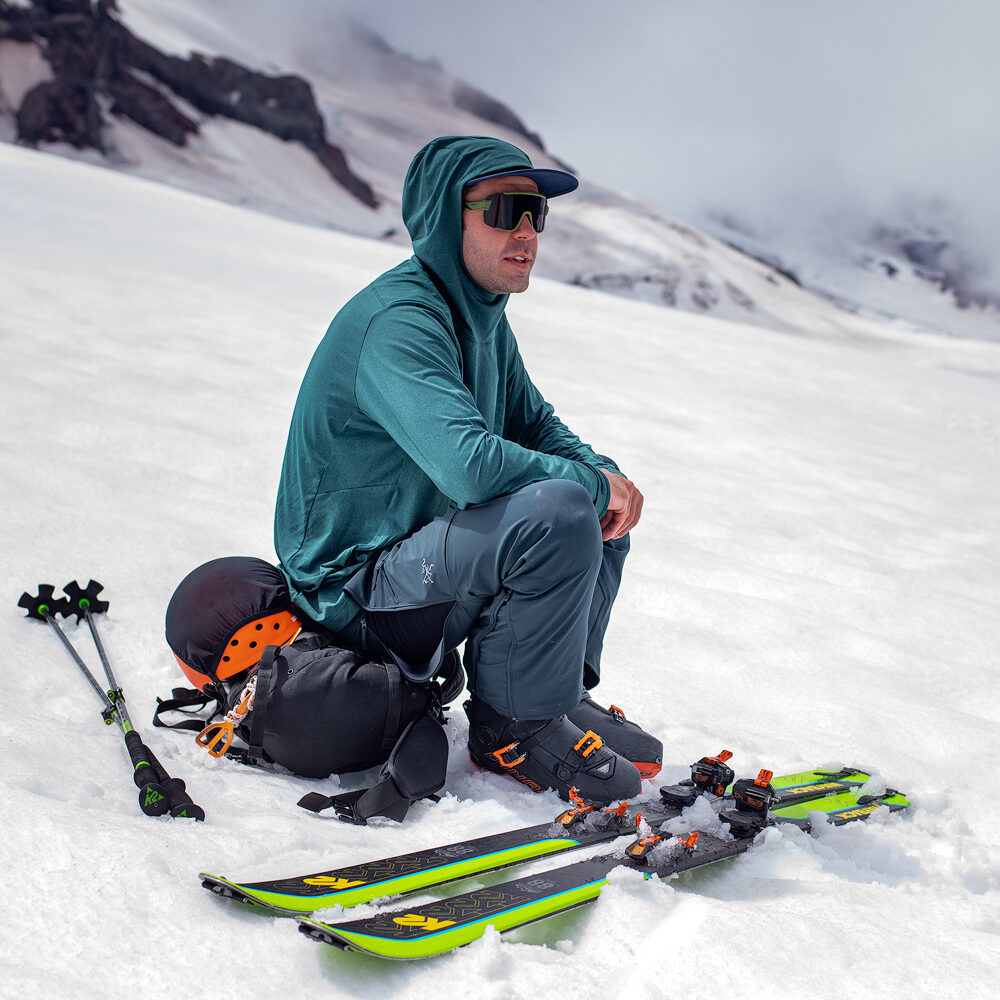 A skier sitting in some icy-looking snow.