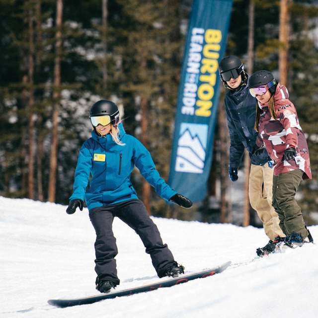 A group of snowboarders shredding down the mountain.