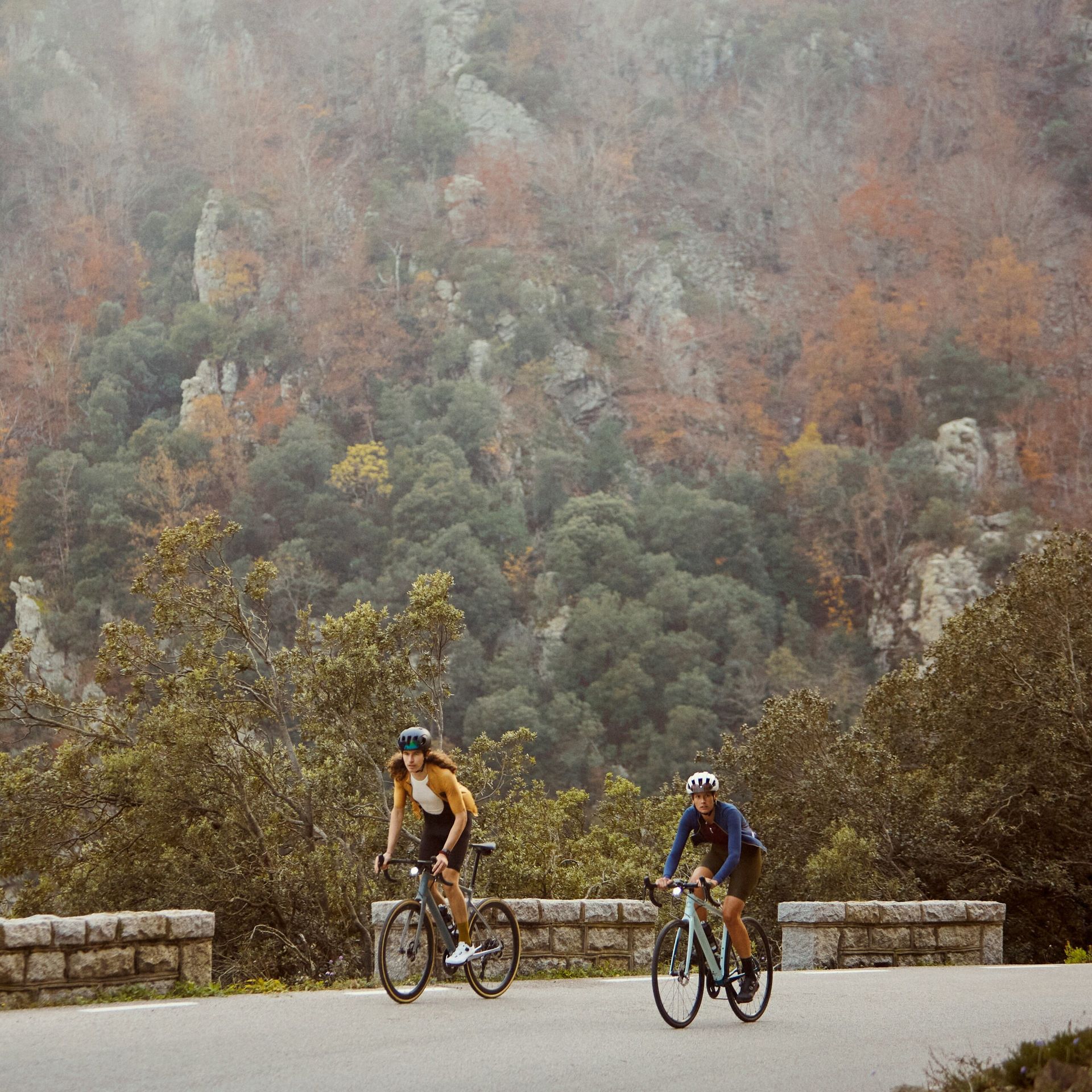 Two people bike path riding in the mountains.