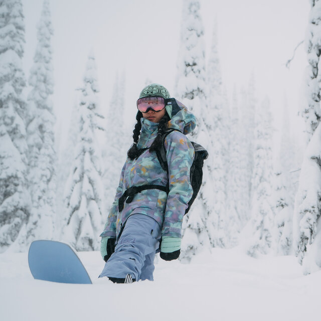 A Burton Snowboarder looking out onto a field of fresh snow.