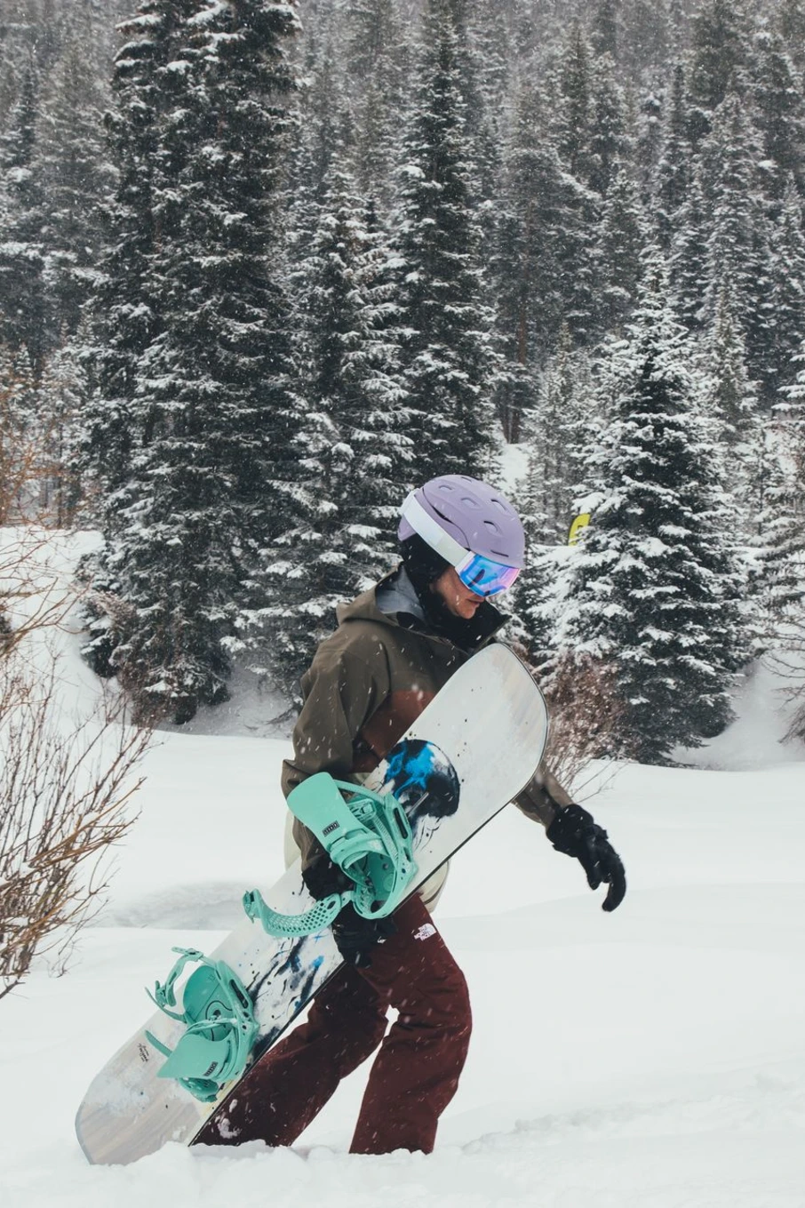 Women carrying a snowboard to the lift