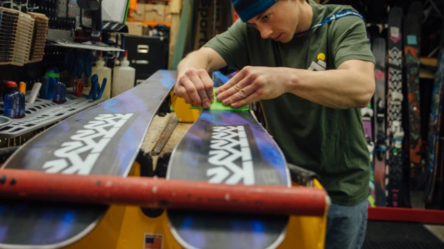 An outdoor expert tuning skis