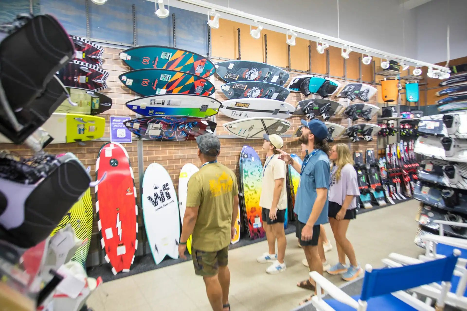 Person choosing a foil in a watersports shop.