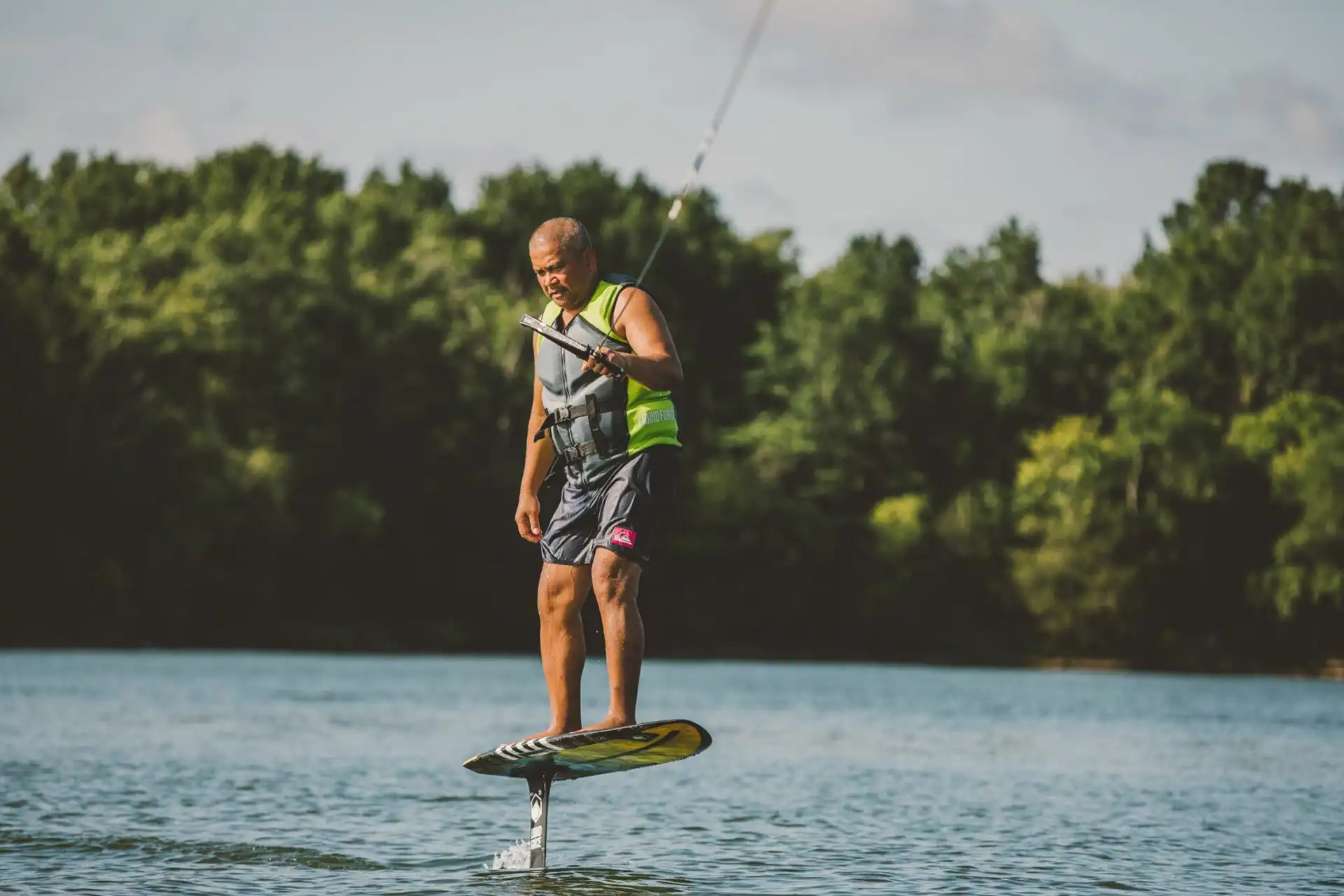 Beginner learning to ride a foil board.